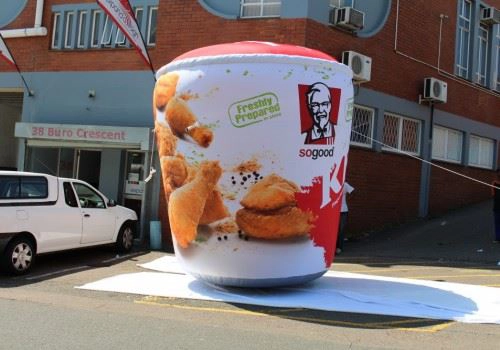 Custom Inflatable KFC chicken bucket used for outdoor event.