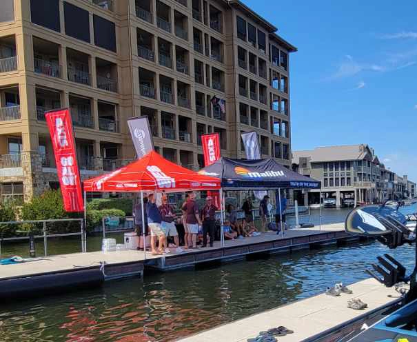 Feather banners and pop-up tent used at Malibu Boats boating event.