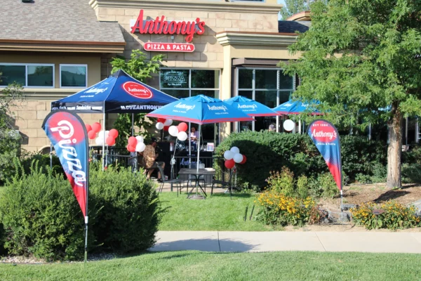 Flying banners, umbrellas and tents used at an Anthony's Pizza new store opening.